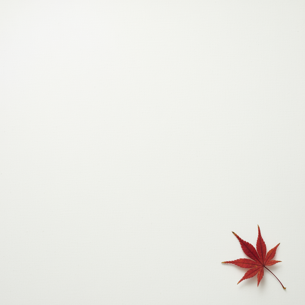 Komposisi minimalis yang menampilkan satu daun maple merah yang halus...