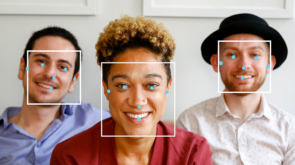 Three people with their faces highlighted with bounding boxes